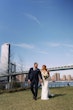 Bride Wearing Lace Crepe Bridal Dress Called Bracken By Sottero And Midgley Walking In A Park With Groom