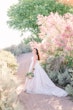 Bride In White Wedding Dress Named Shasta By Sottero and Midgley With Flowers