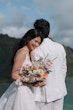 Bride wearing Winter by Maggie Sottero leaning her head on her husband's shoulder