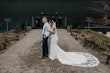 Groom With Bride In White Wedding Dress Named Sadie By Rebecca Ingram In Front Of Green Barn