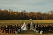 Bride Wearing Lace Mermaid Wedding Gown Called Toccara By Maggie Sottero With Groom At The Outdoor Altar