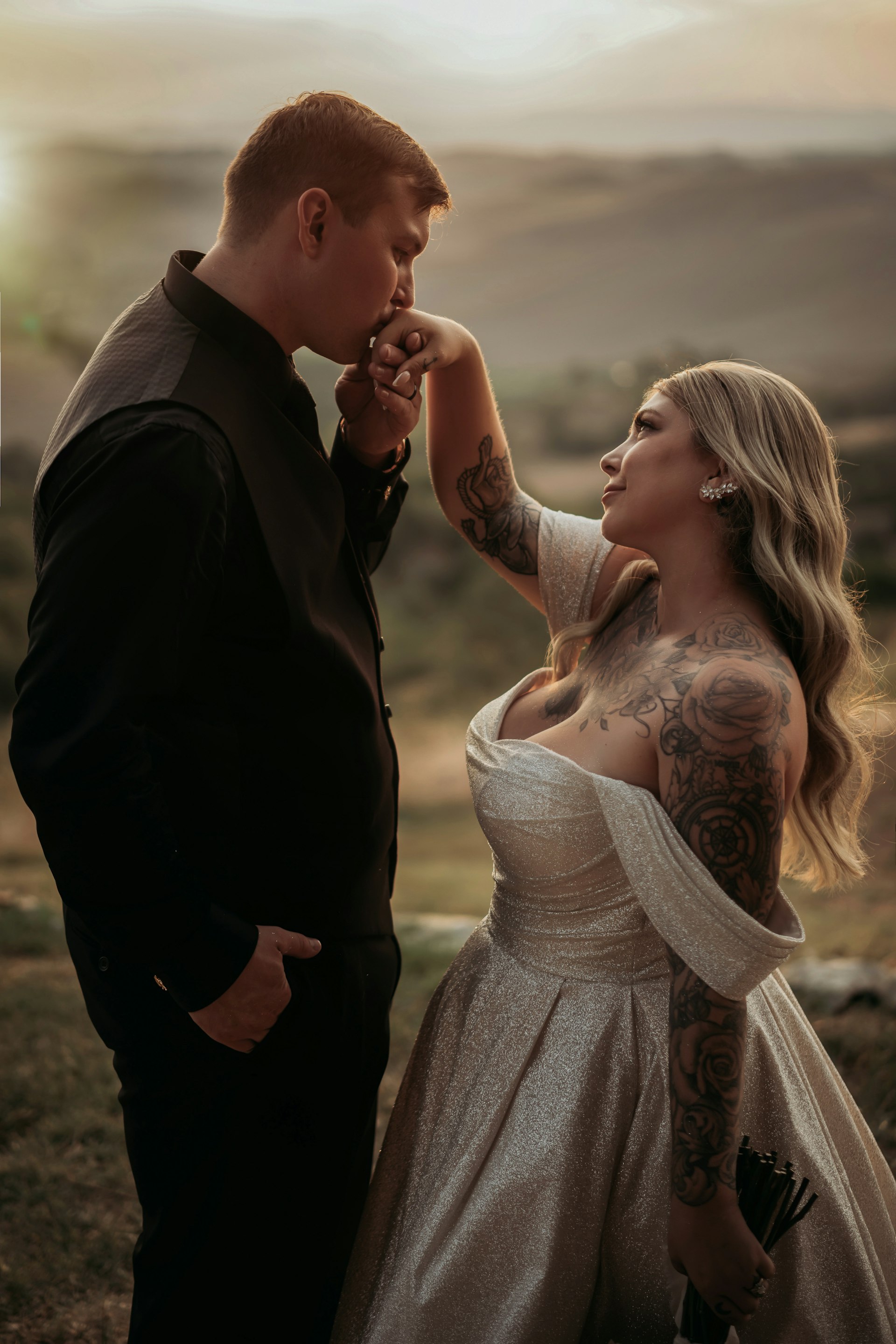 Bride wearing Anniston by Maggie Sottero having her hand kissed by her husband