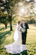 Bride Wearing Nature Lace Wedding Dress Called Albany By Maggie Sottero With Groom In A Sunny Meadow