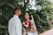 Bride with groom wearing glamorous mermaid wedding dress