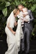 Bride wearing Audrina by Maggie Sottero and her husband playing with a baby