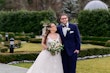 Bride in V neck ballgown called Trinity Lynette by Maggie Sottero with grrom