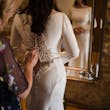 Bride Wearing Simple Keyhole Back Wedding Dress Called Aston By Sottero and Midgley Getting Buttoned Up
