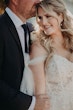 Bride Wearing Off-The-Shoulder Lace Wedding Dress Called Carson By Sottero And Midgley With Groom