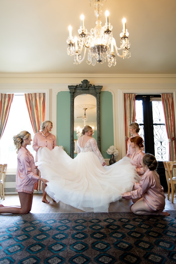 Bridesmaids Laying Brides Wedding Dress Train Out Called Mallory Dawn by Maggie Sottero