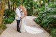 Bride Wearing Lace Mermaid Wedding Dress Called Bronson By Sottero And Midgley Kissing Groom In A Garden