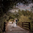 Bride Wearing Sparkly Princess Wedding Dress Called Elton By Sottero And Midgley With Groom On A Bridge