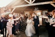 Bride wearing Stevie wedding gown by Maggie Sottero and her husband at their exit