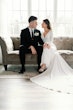 Bride wearing Fernanda wedding dress by Maggie Sottero smiling at her husband