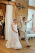 Bride wearing Albany wedding dress by Maggie Sottero celebrating with her husband