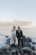 Bride Wearing Sexy Strapless Wedding Dress Called Zelda By Rebecca Ingram With Groom On Rocks