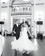 Bride wearing Marvine wedding gown by Sottero and Midgley while dancing with her husband