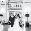 Bride wearing Marvine wedding gown by Sottero and Midgley while dancing with her husband