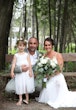 Bride Wearing Simple Chiffon Wedding Dress Called Marta Lynette By Rebecca Ingram With Groom And Flower Girl