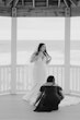 Bride wearing Frederique wedding gown by Maggie Sottero having train fixed