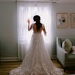 Bride Wearing Lace Long Sleeve Aline Wedding Dress Called Winter By Maggie Sottero Standing Next To A Window