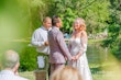 Bride wearing Demetria by Maggie Sottero holding hands with her husband at her ceremony