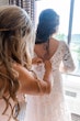 Bride Wearing Dreamy Long Bishop Lace Sleeve Wedding Dress Called Finley By Sottero And Midgley Doing Buttons Getting Ready