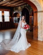 Real Bride Wearing A Fitted White Wedding Dress Named Veronique by Maggie Sottero With Veil And Red Roses