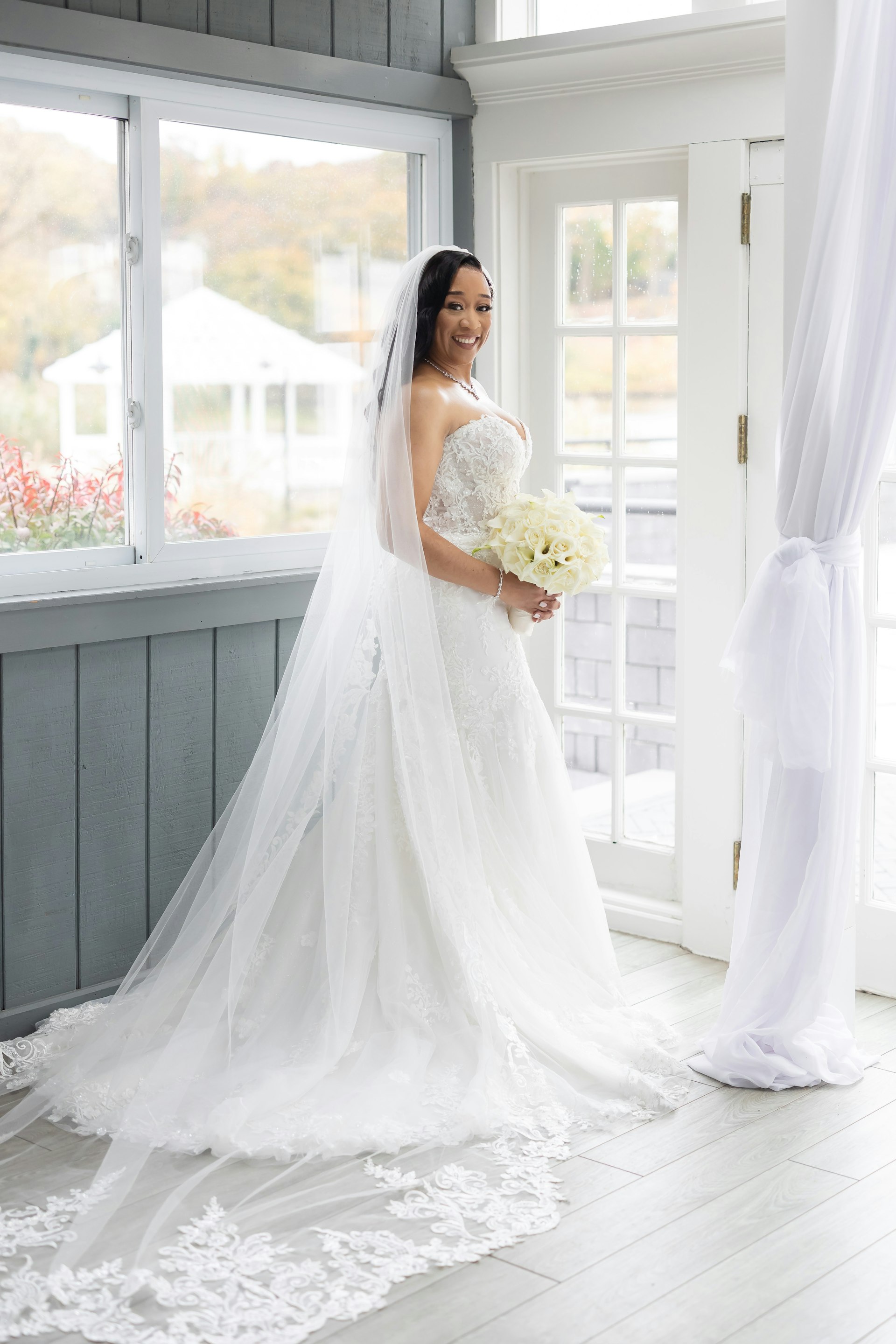 Bride Wearing Sexy Lace Wedding Dress Called Lennon By Maggie Sottero Holding A White Bouquet