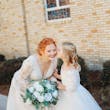 Bride Wearing Lace Long-Sleeve Wedding Gown Called Raphael By Maggie Sottero Getting Kissed By Flower Girl