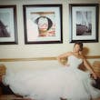 Bride resting on sofa with ball gown wedding dress on called Anastasia.