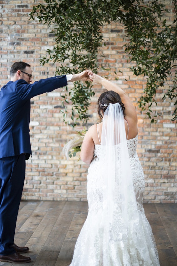 Bride Dancing With Groom Wearing Wedding Dress Called Tuscany Marie by Maggie Sottero