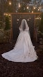 Bride Wearing Floral Ballgown Wedding Dress Called Derrick Marie In A Garden