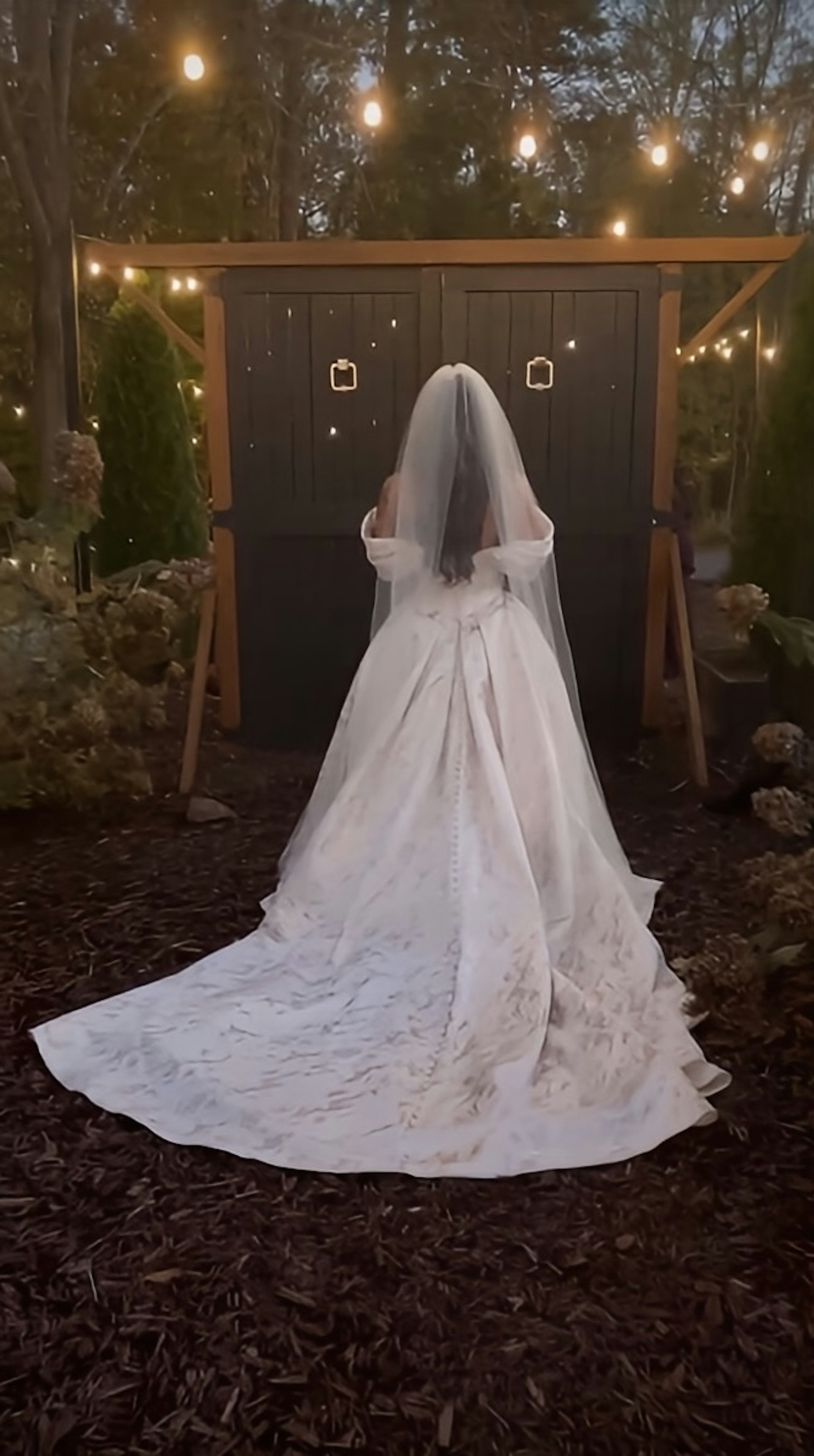 Bride Wearing Floral Ballgown Wedding Dress Called Derrick Marie In A Garden