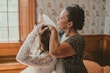 Mother of the bride putting the veil carefully in her hair.