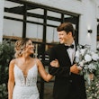 Bride with groom in romantic lace sheath wedding dress