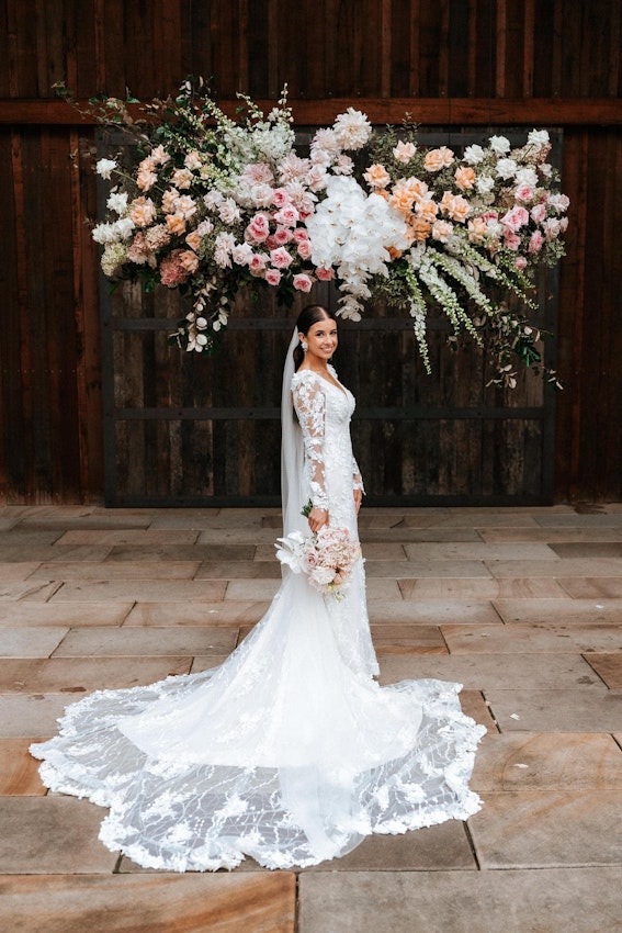 Real Bride wearing puff sleeve wedding dress with 3D floral details called Cruz by Sottero and Midgley..