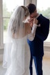 Bride wearing Kensington by Sottero and Midgley having her hand kissed by her husband