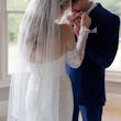 Bride wearing Kensington by Sottero and Midgley having her hand kissed by her husband