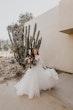 Bride Holding Tulle Skirt Wearing Long Sleeve Lace Ball Gown Called Mallory Dawn By Maggie Sottero