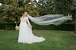 Bride wearing Iris wedding dress by Rebecca Ingram