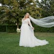 Bride wearing Iris wedding dress by Rebecca Ingram