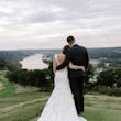 Bride Wearing Lace Backless Wedding Dress Called Chauncey By Sottero And Midgley With Groom On A Hill