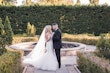 Bride Wearing Lace Mermaid Wedding Dress Called Alistaire By Maggie Sottero With Groom Next To A Fountain