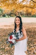 Bride Wearing Crepe Sheath Wedding Dress Called Alda By Rebecca Ingram Holding White And Red Rose Bouquet