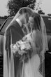 Bride wearing Tuscany Royale by Maggie Sottero with her husband under her veil