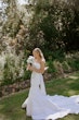 Bride Smelling Roses In A White Strapless Wedding Dress Named Mitchell By Maggie Sottero