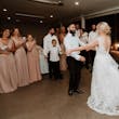 Bride wearing Mindel wedding dress by Maggie Sottero dancing with her husband