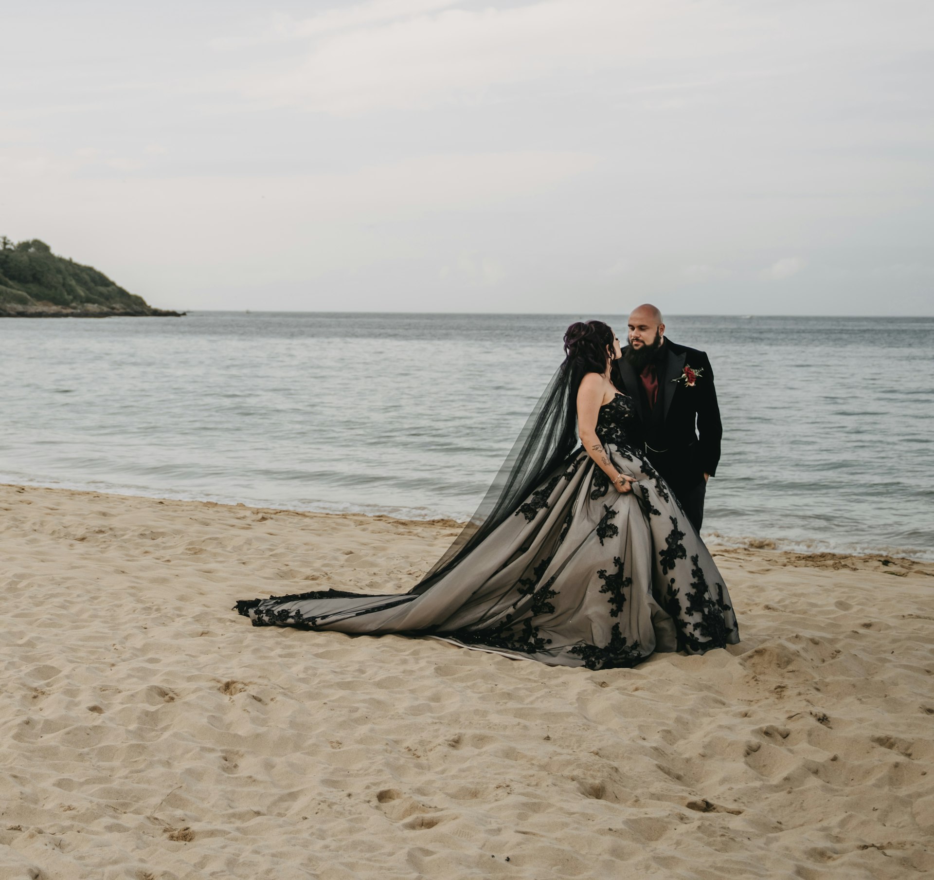 Bride wearing Norvinia by Sottero and Midgley on the beach with her husband