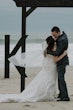 Bride wearing Frederique wedding gown by Maggie Sottero kissing groom