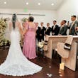 Bride Wearing Lace Fit And Flare Wedding Dress Called Fairchild By Maggie Sottero Walking Down The Aisle With Her Mom In A Floral Pink Dress